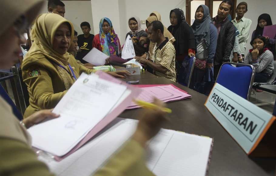 Sejumlah siswa didampingi wali siswa mengantre untuk mendaftar Sekolah Menengah Pertama (SMP) di kantor Dinas Pendidikan Kota Solo, Jawa Tengah, Senin (25/6).